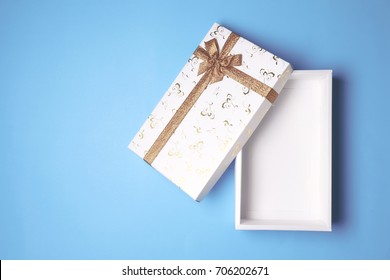 Top View Of Open White Gift Box On Blue Background. Free Space For Text