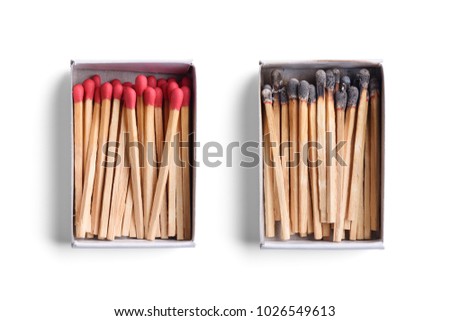 Top view of opened match boxes with burned matchsticks. Isolated on white background