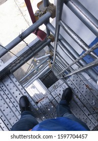 Top View Of An Opening On The Scaffold In A Construction Site With A Metal Ladder Attached On The Guardrail. Alert Of Construction Safety.