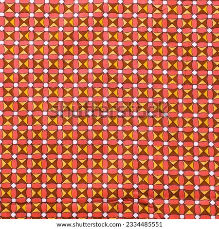 top view of orange ankara fabric, flatlay of nigerian wax orange ankara material on a table