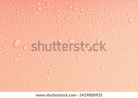 top view of an orange-colored surface with irregular water droplets. background of water drops