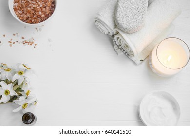 Top View Of Organic Spa Skincare Products With Salt, Candle, Flowers, Essential Oil,face Cream, Towels And Pumice Stone