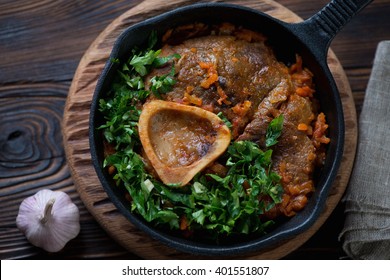 Top view of ossobuco made of cross cut veal shank with gremolata, close-up