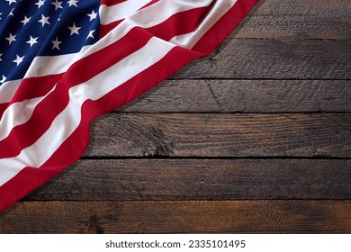 Top view overhead America United States flag, memorial remembrance and thank you of hero, studio shot with copy space on wooden table background, USA holiday Veterans or Independence day concept.