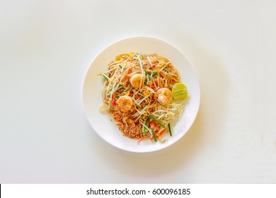 Top View Of Pad Thai In White Plate On White Background, Stir Fry Noodles With Shrimp 
