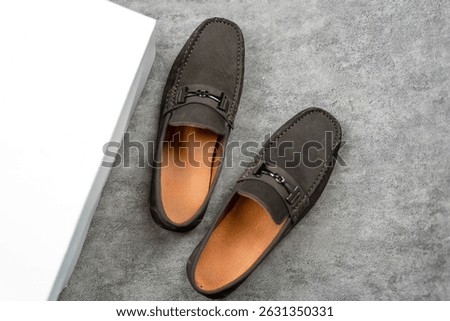 Top view of a pair of stylish brown leather loafers