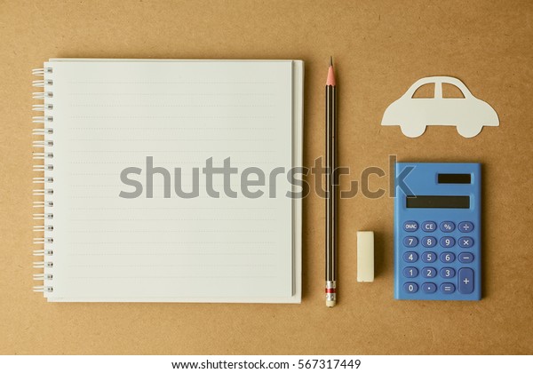 top view of a paper car, copy space notebook, pencil and\
calculator for finance management about a car background           \
               