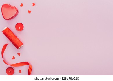 top view of paper hearts, thread and candles isolated on pink with copy space, st valentines day concept - Shutterstock ID 1296986320