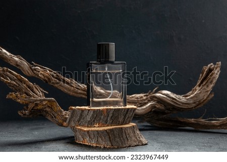 Top view of parfum on two wooden cutting boards stacked on top of each other on dark color background with free space