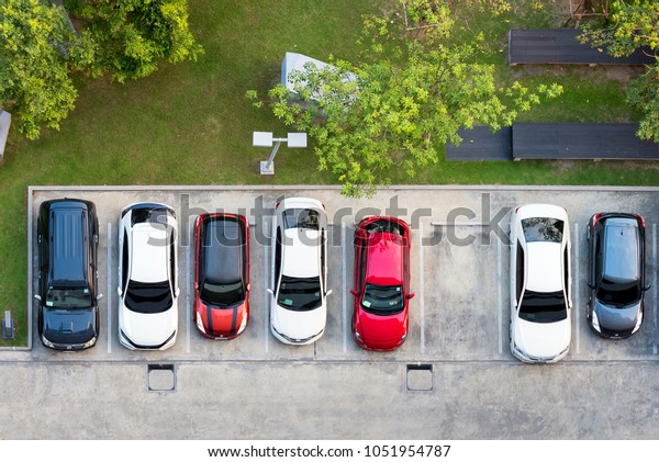 Top view of parking area with small garden in\
modern building
