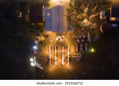 Top view of the party with dining table and people in wedding celebration with light glowing at night