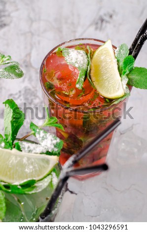 Top view passion fruit, berry summer and mojito with lime and mint drink on gray stone table background. Bar alcohol drink menu