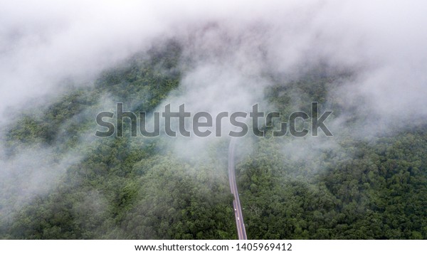 Top view of the path through the trees View\
from drone, Aerial View in Thailand\
Road