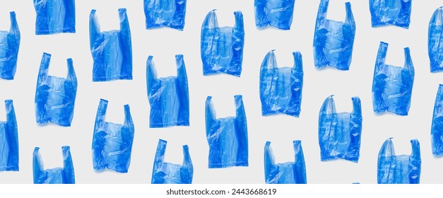 Top view pattern from blue plastic bags, wide banner. Single-use empty polythene packet, Eco trend to reduce disposable plastics, Biodegradable packaging waste, trendy photo pattern, design background