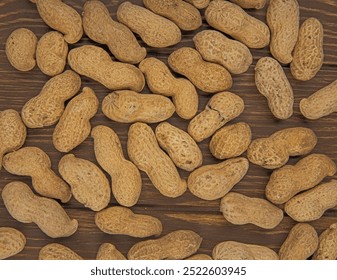 top view of peanuts in shell scattered on wooden background - Powered by Shutterstock