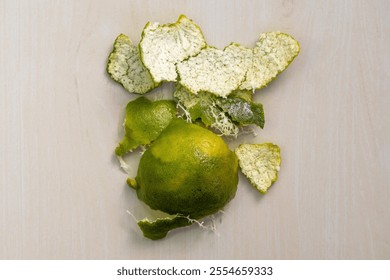 Top view of a peeled sweet orange skin on a wooden surface. - Powered by Shutterstock