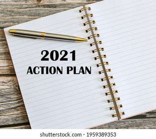 Top View Of A Pen With 2021 Action Plan Written On A Notebook.