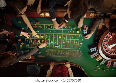 Top View Of People Playing Roulette At The Table In A Casino