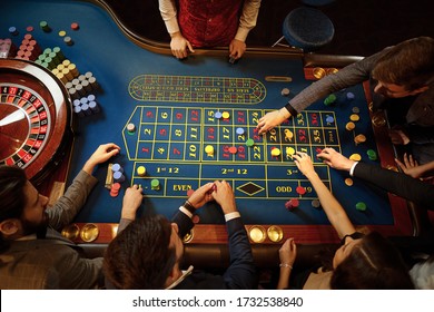 Top View Of People Playing Roulette At The Table In A Casino