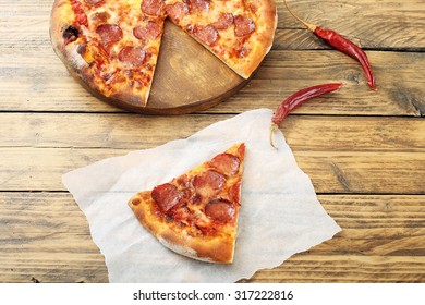 Top View Pepperoni Pizza Slice On Rustic Table Background