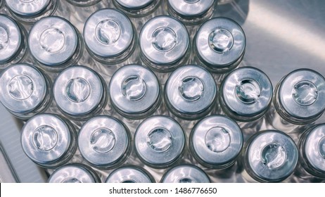 Top View - Pharmaceutical Automatic Production Line - Conveyor Belt With Empty Glass Bottles At Pharmacy Processing Factory. Manufacturing, Pharma, Medicine, Healthcare, Automated Technology Concept