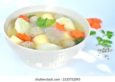 Top view photo of Bowl Soup , Vermicelli, Tofu and Minced Pork. Cabbage with Carrots in a white bowl placed on the white table It is a nutritious food that contains all 5 food groups.