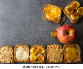 Top View Photo Of Breakfast Table: Apple And Toasts With Different Toppings: Peanut Butter, Jam, Butter And Caramelized Banana. 