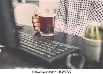 Top View Photo Of Busy Man Holding Cup Of Coffee And Working.