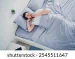 Top view photo of funny young man nightwear pajama lying bed yawning indoors house apartment room