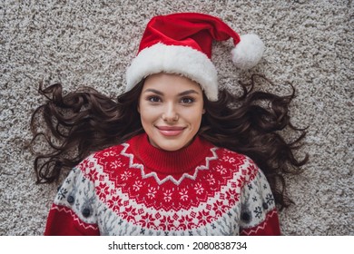 Top View Photo Portrait Smiling Woman Wearing Headwear Laying On Floor In Xmas Clothes