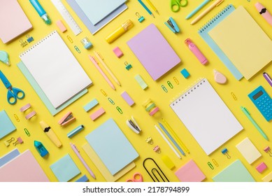 Top view photo school supplies notebooks pencils correctors marker pens binder clips stapler calculator ruler adhesive tape scissors sharpener eraser sticky note paper isolated yellow background