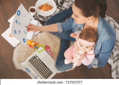 Top View Photo Of Single Mom Working At Home