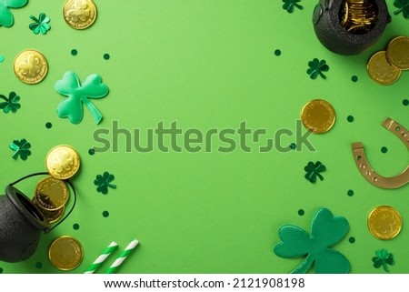 Top view photo of st patrick's day decorations pots with gold coins green shamrocks horseshoe straws and trefoil shaped confetti on isolated pastel green background with copyspace