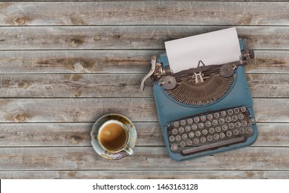 Top View Photo Of Vintage Typewriter With Blank Page Next To Cup Of Coffee, On Wooden Table.