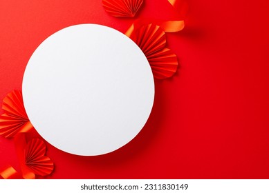 Top view photo of white empty circle surrounded by bright red ribbon and paper origami hearts on isolated red background with copy-space - Shutterstock ID 2311830149