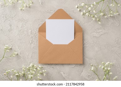 Top view photo of woman's day composition open craft paper envelope with paper card and white gypsophila flowers on isolated textured grey concrete background with empty space - Shutterstock ID 2117842958