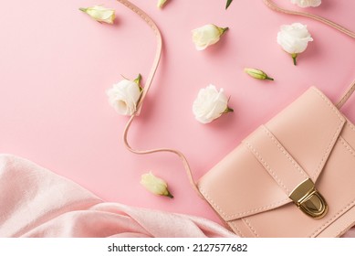 Top View Photo Of Woman's Day Composition Pink Leather Handbag Soft Textile And White Prairie Gentian Flower Buds On Isolated Pastel Pink Background With Copyspace