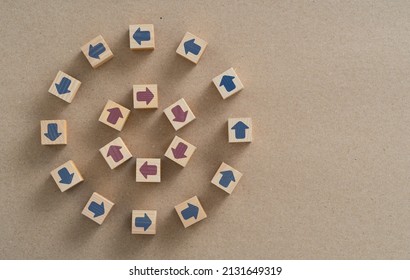 Top view photo of wooden blocks with arrows pointing opposite direction. Concept of opposition, conflict, disruption, contradiction and dispute.
