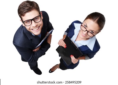 Top View Photo Of Young Business Man And Woman With Glasses. They Holding Folders And Looking At Camera. Isolated On White Background