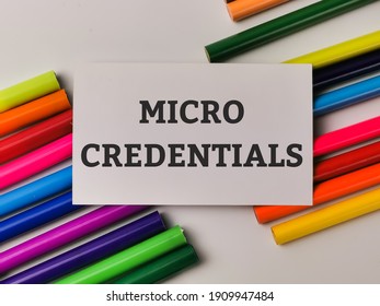 Top View Phrase MICRO CREDENTIALS On White Card With Colorful Pencils. Education Concept.