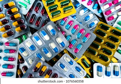 Top view pile of antibiotic capsule pills in blister pack. Drug interactions. Pharmaceutical industry. Drug production. Antibiotic drug resistance concept. Pharmacy product. Antimicrobial drug.