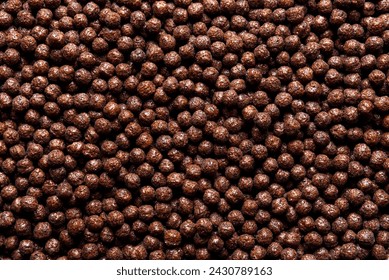 Top view with a pile of chocolate cereals. Full frame background with delicious chocolate cornflakes balls - Powered by Shutterstock