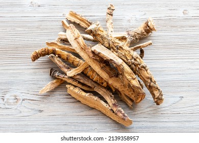 top view of pile of dried Sweet flag (calamus) roots on gray wooden table