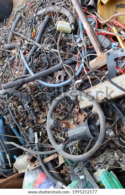 Top view of a pile of old wires,\
discarded car parts for reuse, recycling\
concept.