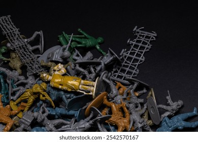 Top view of a pile of toy soldiers on a grey background with copy space, chaos never dies day - Powered by Shutterstock