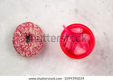 top view pink donut and cold drink
