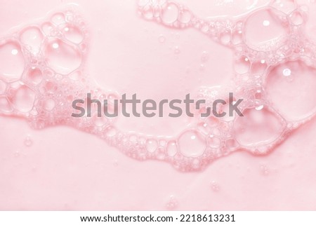 Top view pink soap bar wet with bubbles