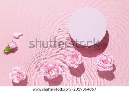 Top view of pink transparent clear calm water surface. Texture with splashes and bubbles and podium for cosmetics product. Trendy abstract summer nature cosmetic background