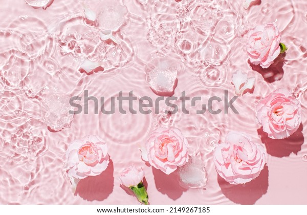 Top view of pink transparent clear calm water surface. Texture with splashes and bubbles and podium for cosmetics product. Trendy abstract summer nature cosmetic background,