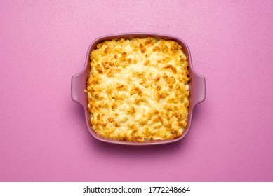 Top View With A Pink Tray With Mac And Cheese Baked With White Sauce. Freshly Baked Macaroni And Cheese On A Pink Background, Above View